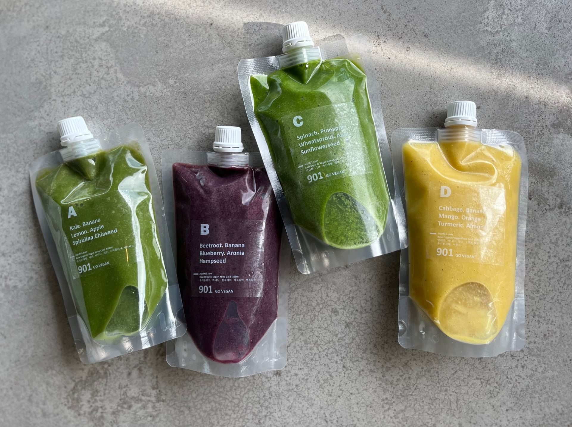 Four pouches of cold-blended detox smoothies labelled A, B, C, and D