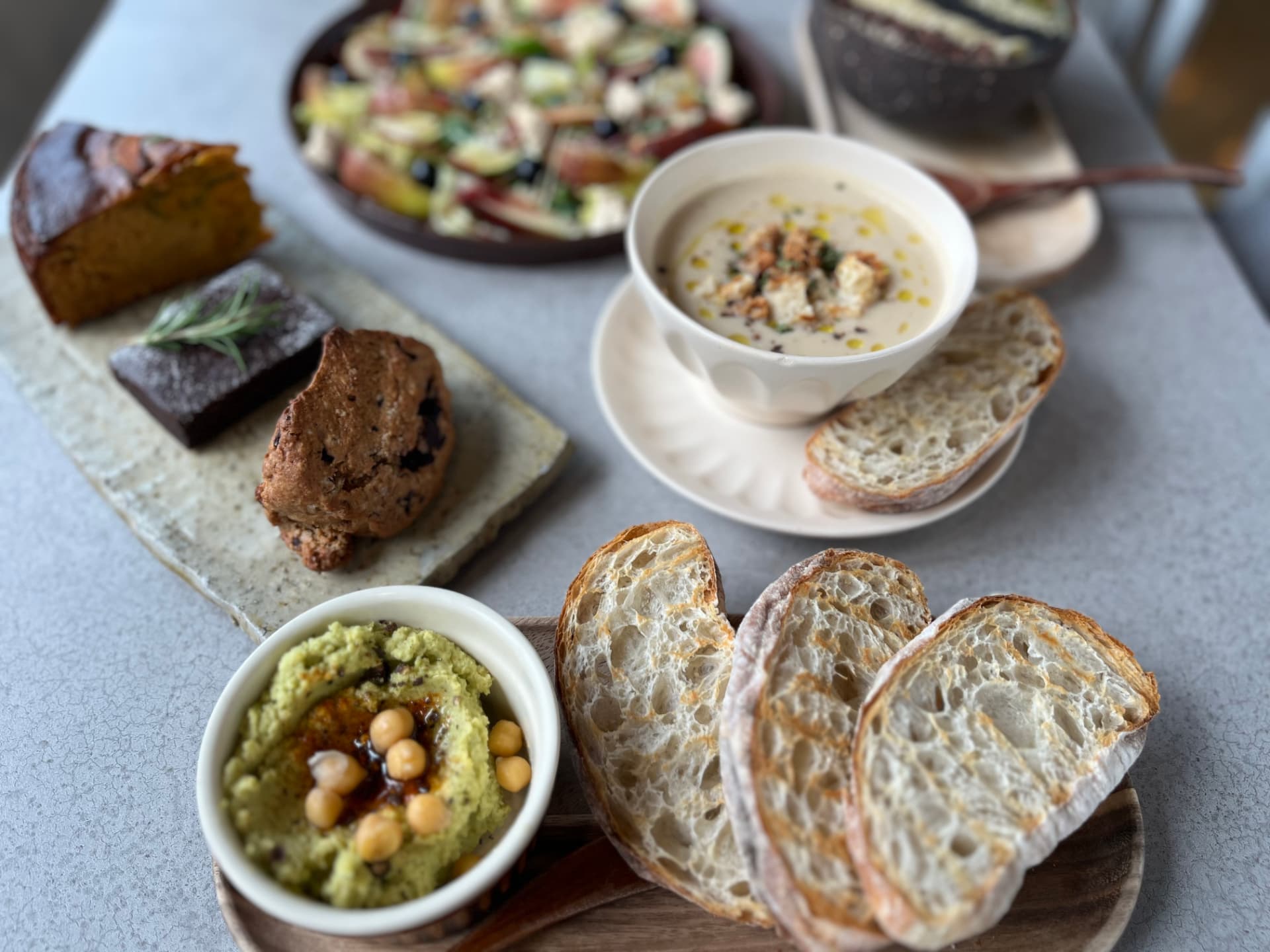 Vegan soup with warm ciabatta, hummus, and salad