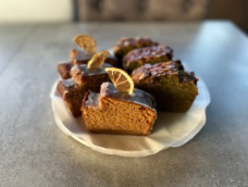 Slices of wholewheat pound cake with dried orange on a plate